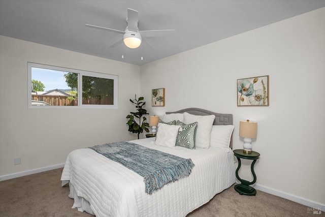 bedroom with baseboards, carpet, and a ceiling fan