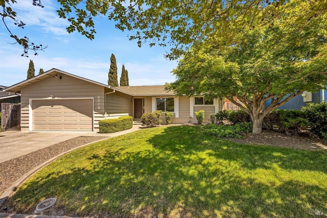single story home with an attached garage, a front yard, and concrete driveway