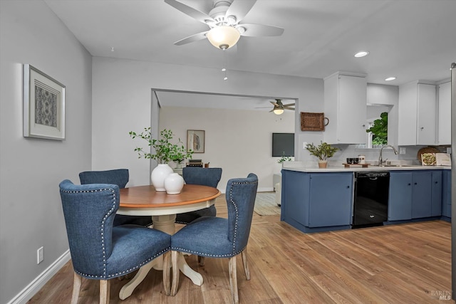 dining space featuring light wood-style floors, a ceiling fan, baseboards, and recessed lighting