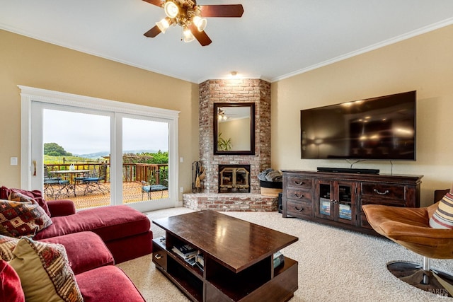 carpeted living room with a ceiling fan, crown molding, and a brick fireplace