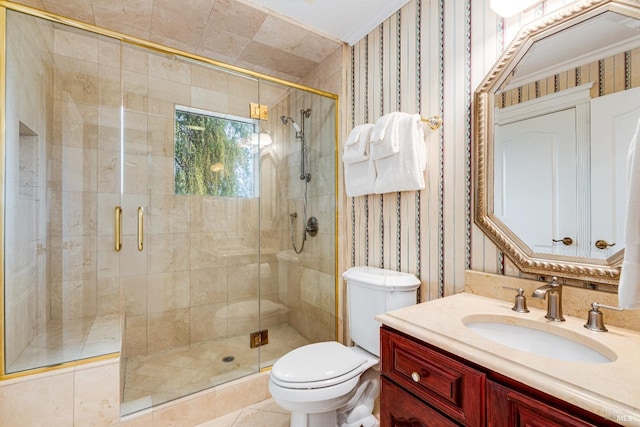bathroom featuring wallpapered walls, a stall shower, toilet, and vanity