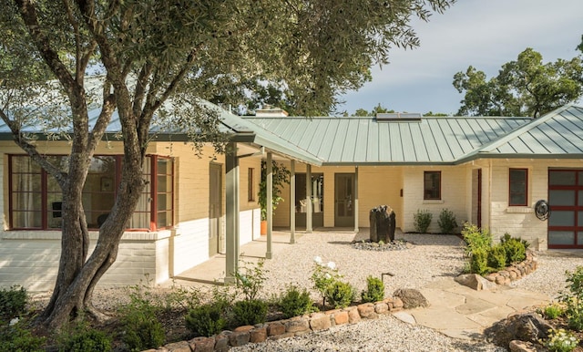 2480 Spring Mountain Rd, Saint Helena, CA 94574 - rear view of property with a standing seam roof, brick siding, and a metal roof