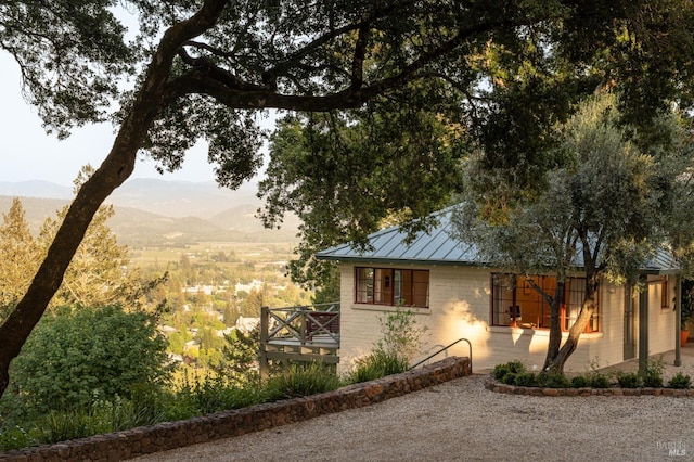 2480 Spring Mountain Rd, Saint Helena, CA 94574 - view of front facade featuring a mountain view, a standing seam roof, brick siding, and a metal roof