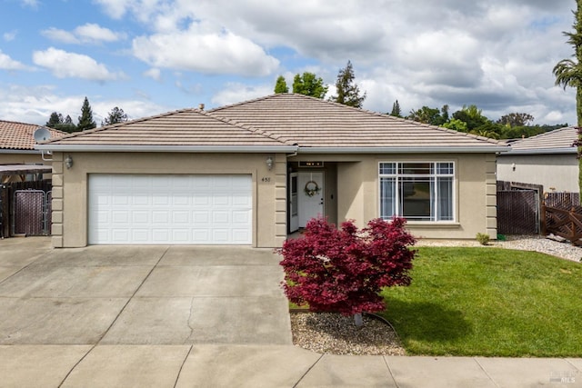 ranch-style home with a front lawn, a garage, concrete driveway, stucco siding, and fence