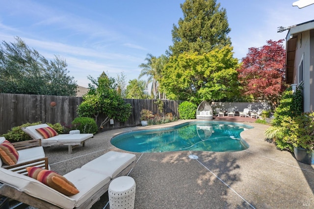 view of pool featuring a fenced backyard, a fenced in pool, and a patio