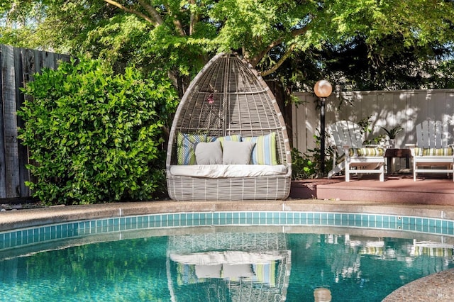 view of pool featuring a fenced backyard, a fenced in pool, and an outdoor living space