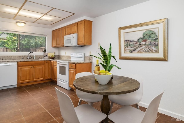 728 Walnut Ct, Novato, CA 94945 - kitchen with white appliances, a sink, dark tile patterned floors, light stone counters, and brown cabinets