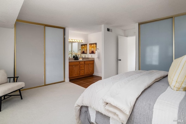 728 Walnut Ct, Novato, CA 94945 - bedroom with connected bathroom, a textured ceiling, dark tile patterned floors, dark colored carpet, and baseboards