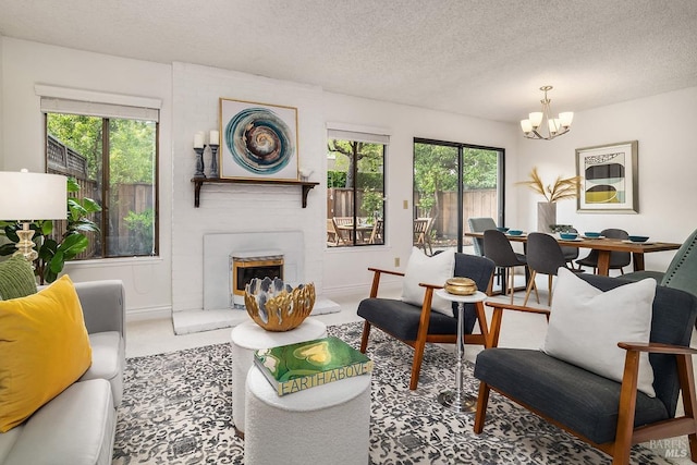 728 Walnut Ct, Novato, CA 94945 - living room featuring a chandelier, plenty of natural light, a brick fireplace, a textured ceiling, and baseboards