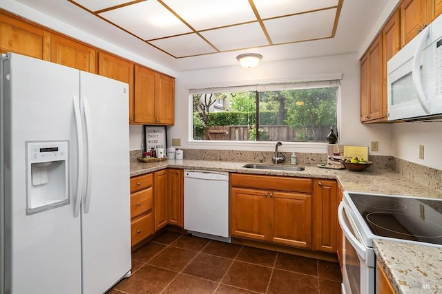 728 Walnut Ct, Novato, CA 94945 - kitchen featuring white appliances, a sink, brown cabinetry, dark tile patterned floors, and light stone counters