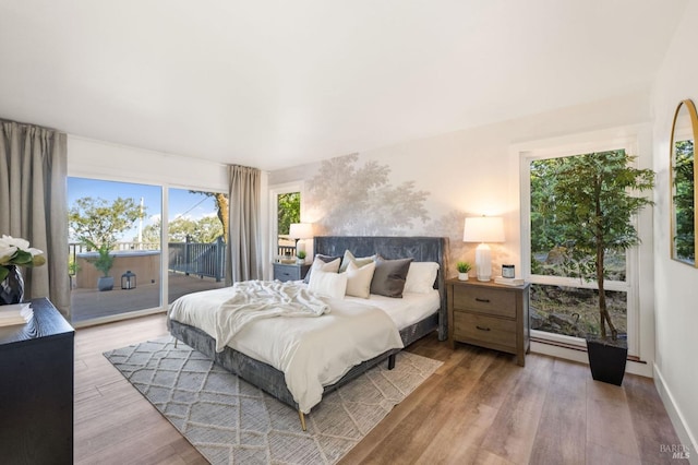 bedroom featuring wood finished floors and access to outside
