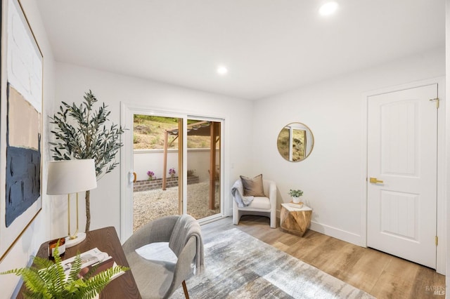interior space with baseboards, recessed lighting, and wood finished floors