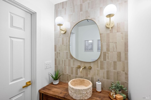 bathroom featuring tile walls and a sink