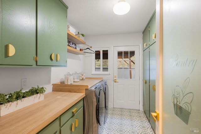 laundry area with washing machine and dryer and cabinet space