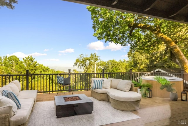 wooden terrace with an outdoor living space with a fire pit and a hot tub