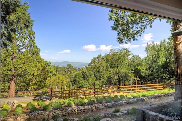 exterior space featuring a mountain view and a view of trees