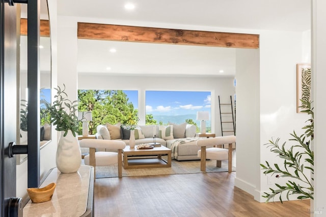 living room featuring wood finished floors, recessed lighting, beamed ceiling, and baseboards
