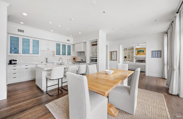 72 Lagoon Rd, Belvedere, CA 94920 - dining space featuring dark wood finished floors, recessed lighting, and ornamental molding