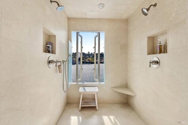 72 Lagoon Rd, Belvedere, CA 94920 - full bath with a water view, tiled shower, tile patterned floors, and tile walls