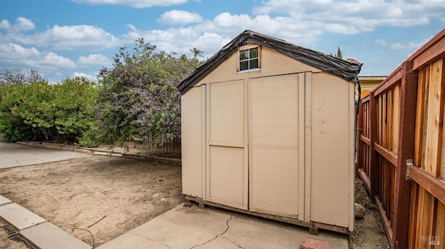 view of shed with fence