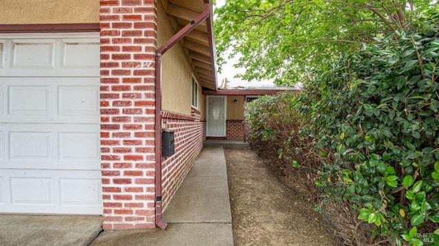 view of home's exterior featuring a garage and brick siding