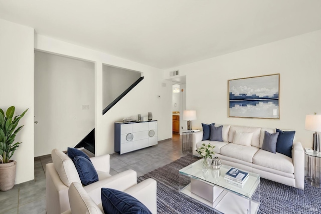living area featuring tile patterned floors and visible vents