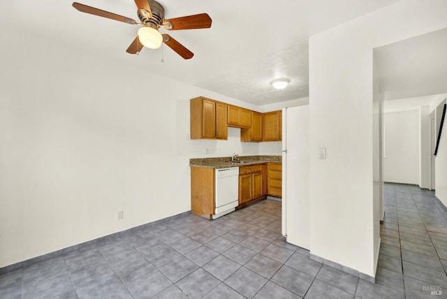 kitchen with white dishwasher, a sink, a ceiling fan, and light tile patterned flooring