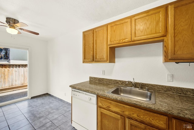 kitchen with ceiling fan, dark countertops, brown cabinets, dishwasher, and a sink