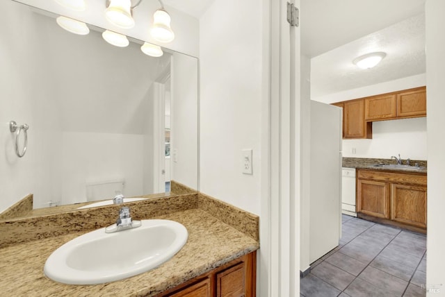 bathroom with toilet, tile patterned flooring, and vanity