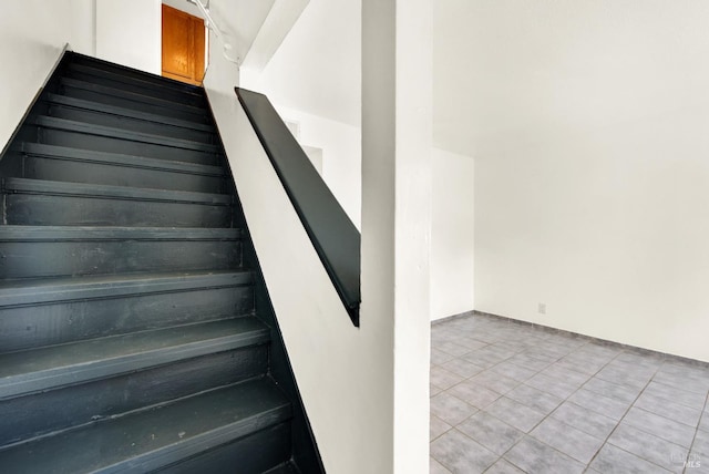 stairway with tile patterned floors