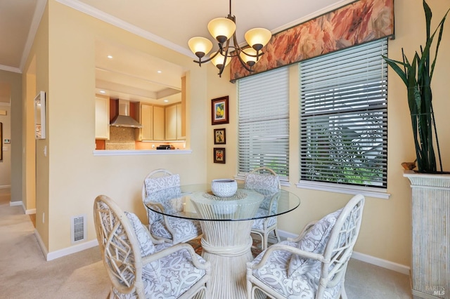 dining room featuring an inviting chandelier, crown molding, baseboards, and light carpet