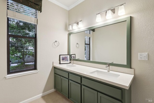 full bathroom with crown molding, double vanity, a sink, and baseboards