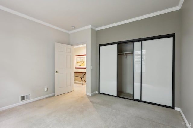 unfurnished bedroom with crown molding, visible vents, light colored carpet, and baseboards