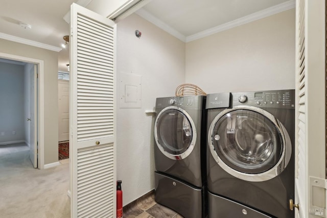 laundry area featuring crown molding, carpet flooring, baseboards, washer and clothes dryer, and laundry area