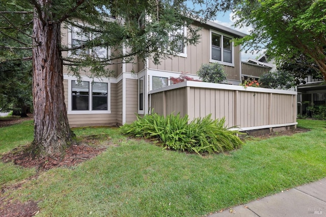 view of side of property with a yard