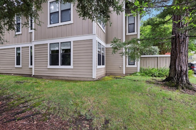 rear view of house featuring a yard