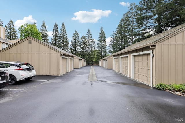 view of road featuring community garages