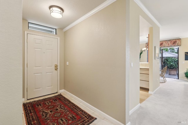 entryway featuring ornamental molding and baseboards