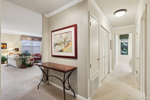 hall featuring light carpet, crown molding, and plenty of natural light