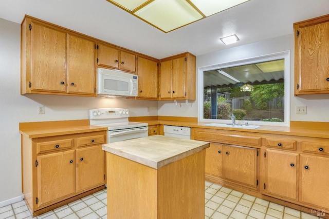 kitchen featuring a center island, a sink, wood counters, and white appliances