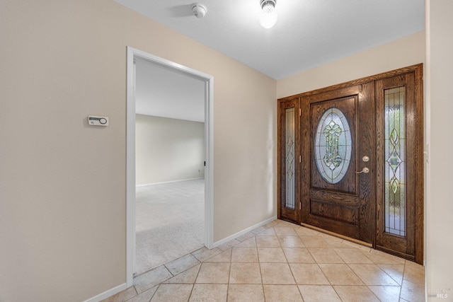 foyer with light tile patterned floors and baseboards