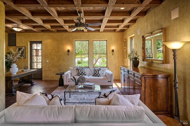 living area featuring coffered ceiling, ceiling fan, and beam ceiling