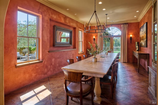 dining space featuring crown molding, recessed lighting, and a chandelier