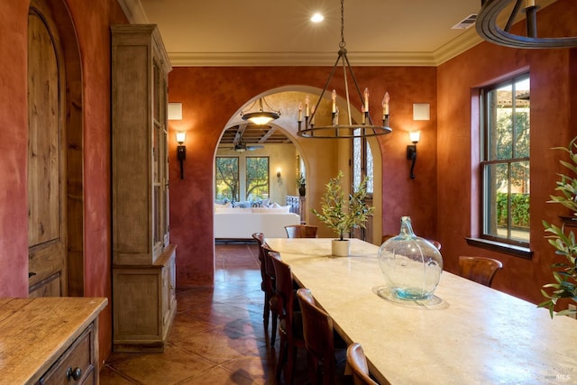 dining room with a notable chandelier, visible vents, ornamental molding, and a healthy amount of sunlight