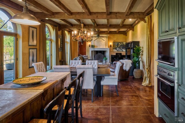 dining area with an inviting chandelier, coffered ceiling, a fireplace, and beamed ceiling