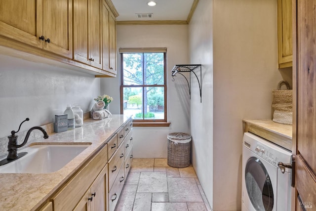 washroom with washer / clothes dryer, visible vents, crown molding, cabinet space, and a sink