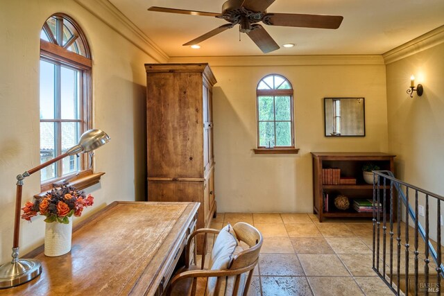 interior space with ornamental molding, ceiling fan, and stone tile floors