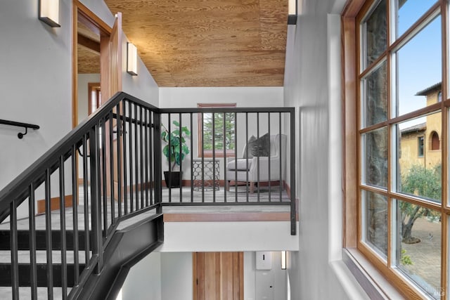 stairway with wooden ceiling