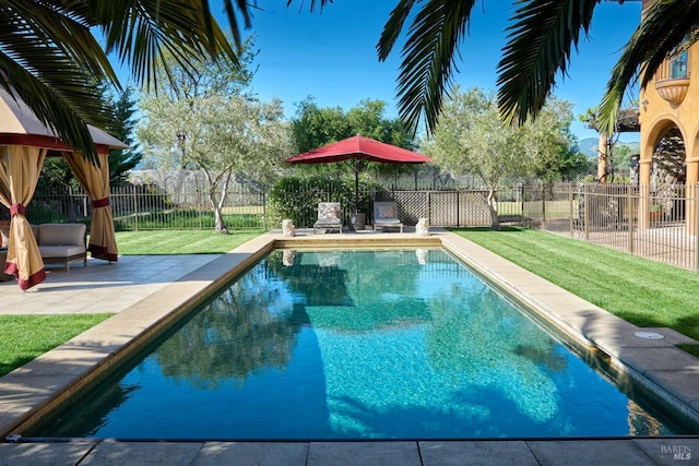 view of pool featuring a patio, a fenced backyard, a lawn, and a fenced in pool