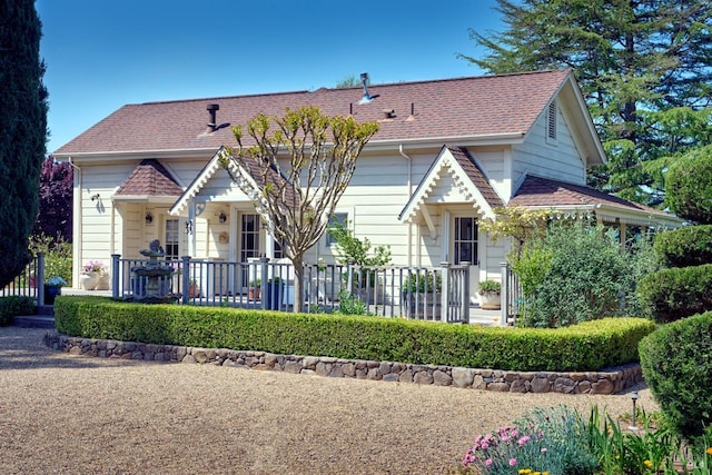 view of front of property featuring roof with shingles